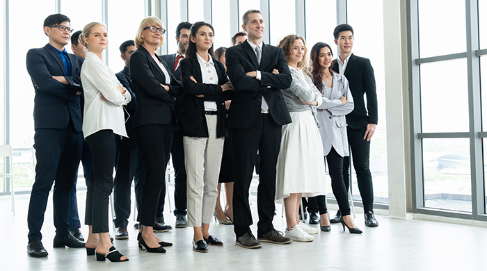 Group of Business Leaders Managers Standing in Front of Windows